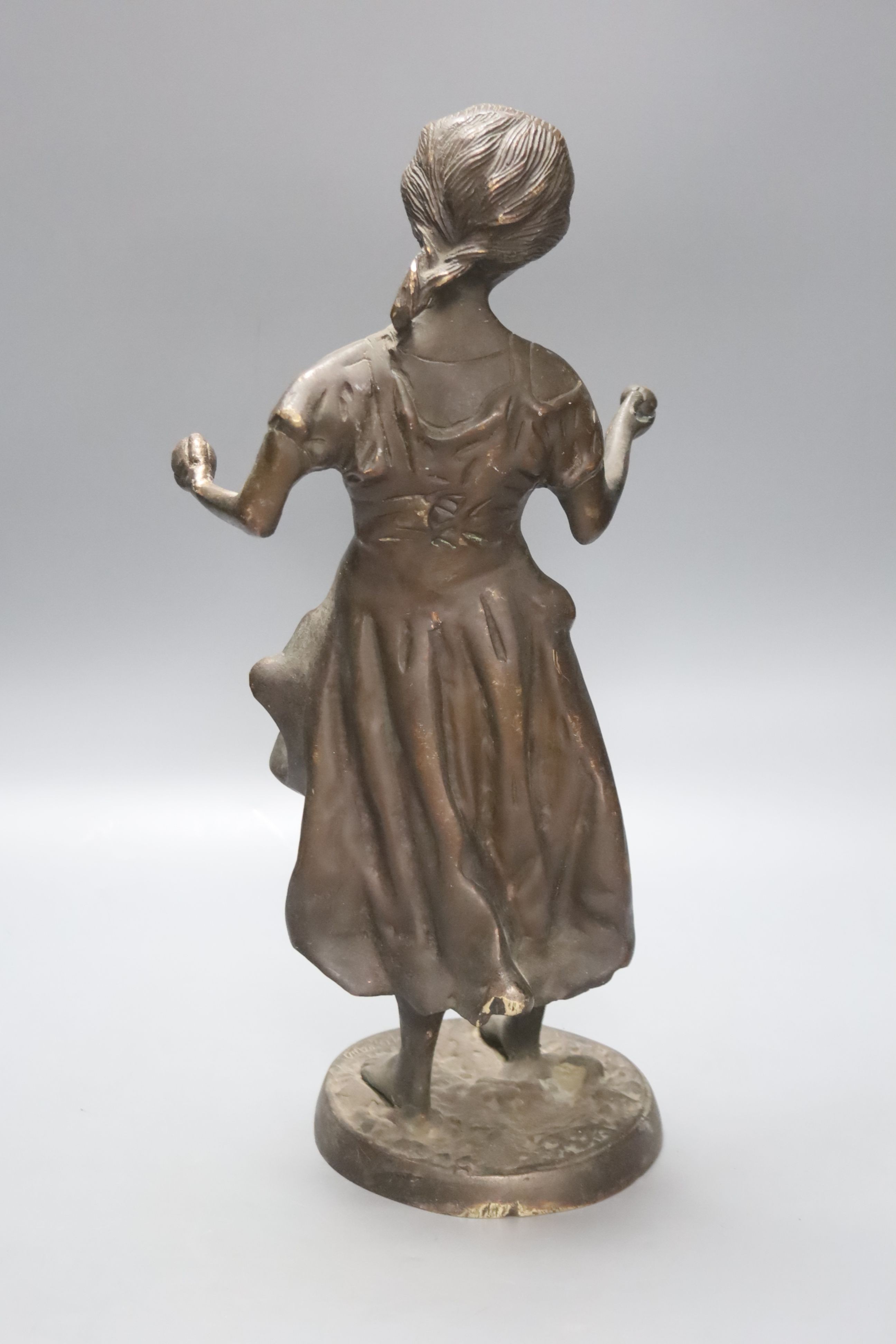 After Moreau. A bronze female figure, script signature to circular base, height 38cm